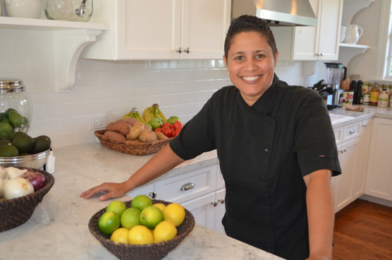 Chef Angelique Santana standing in her kitchen