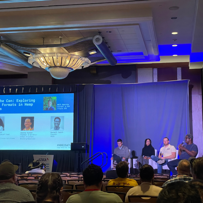 Four people sitting on a stage