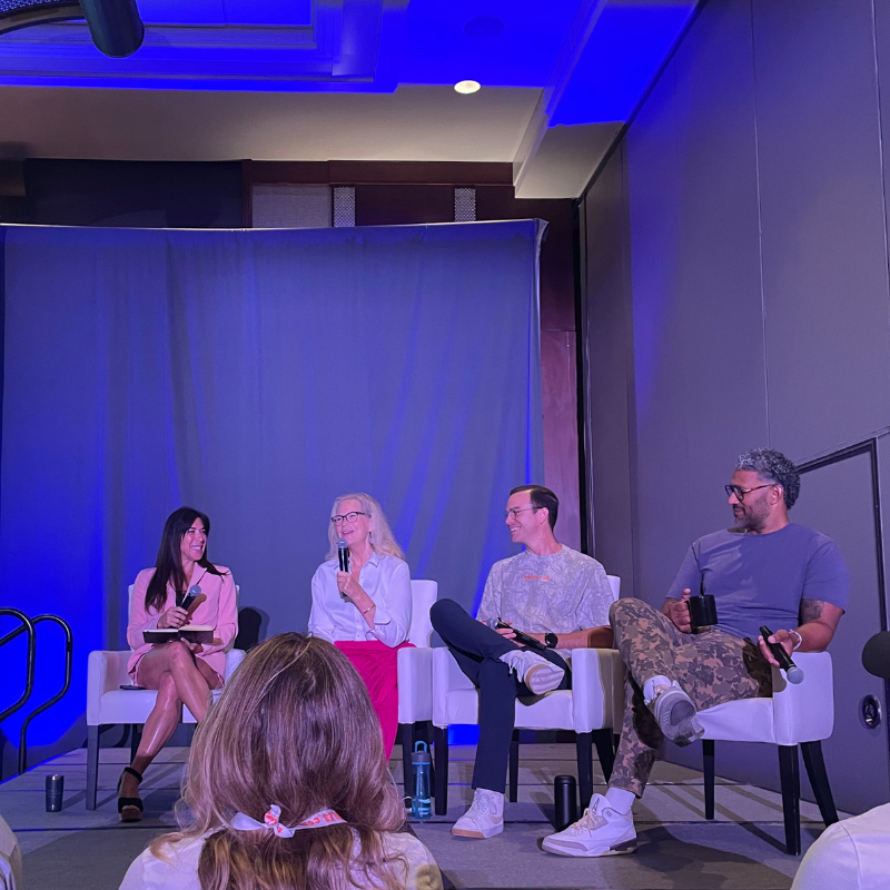 4 people sitting on a panel stage